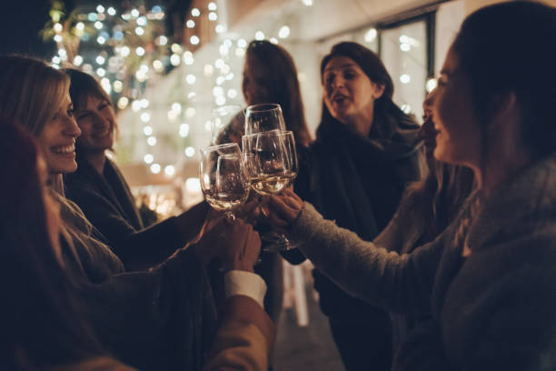 Smiling women enjoying in wine and spending great time in night out